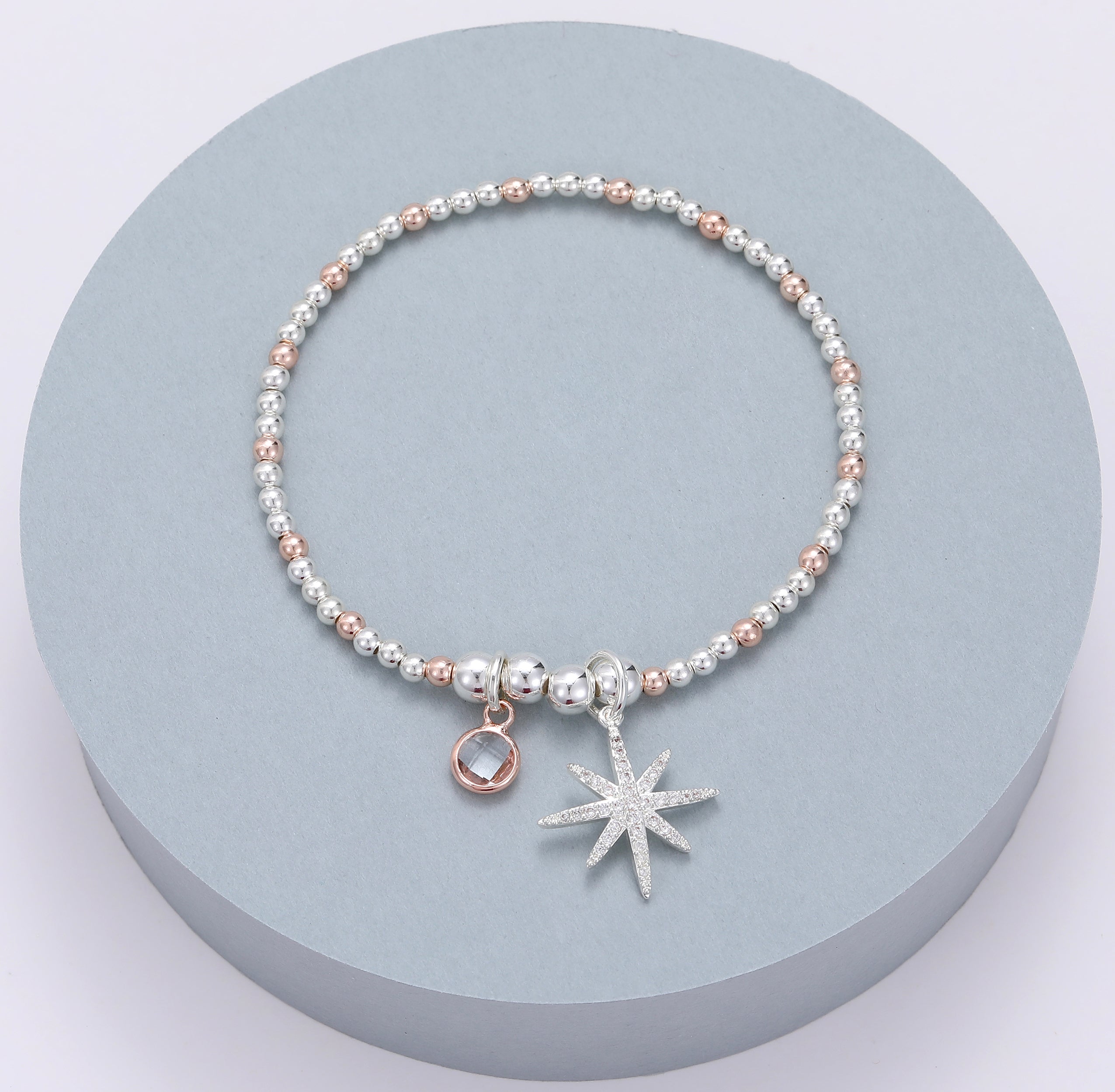 Elasticated bracelet with silver and rose gold beading and silver diamanté shining star