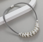 Short necklace, with interlocked silver rings and magnetic opening/closure  - on leather strands