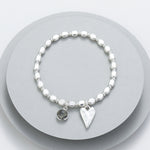 Elasticated bracelet with silver beads - with a grey charm and battered heart motif