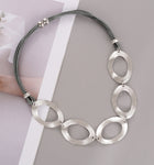 Short necklace, with interlinked silver open rings and magnetic opening/closure  - on leather strands
