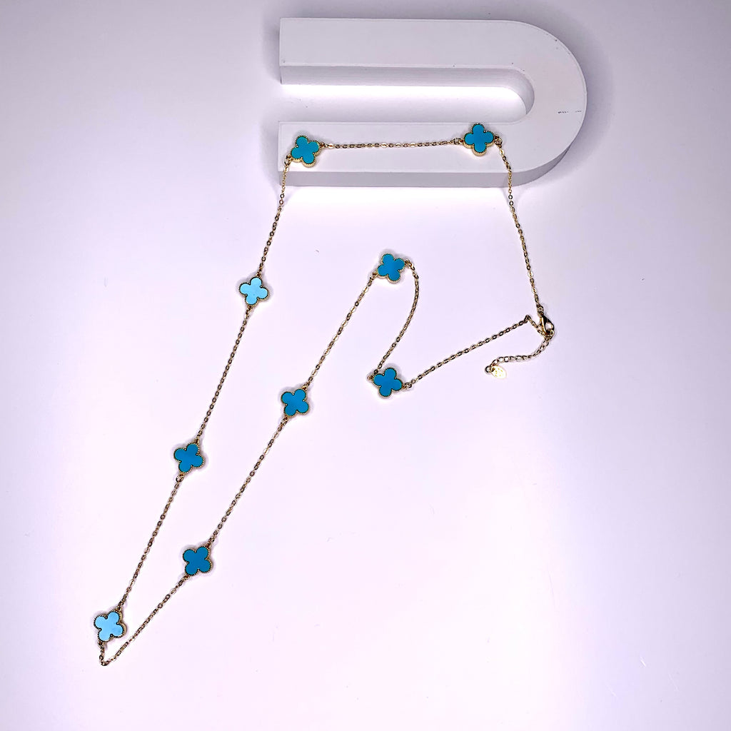 Long necklace with aqua blue four-leaf clover stations on a gold paper chain