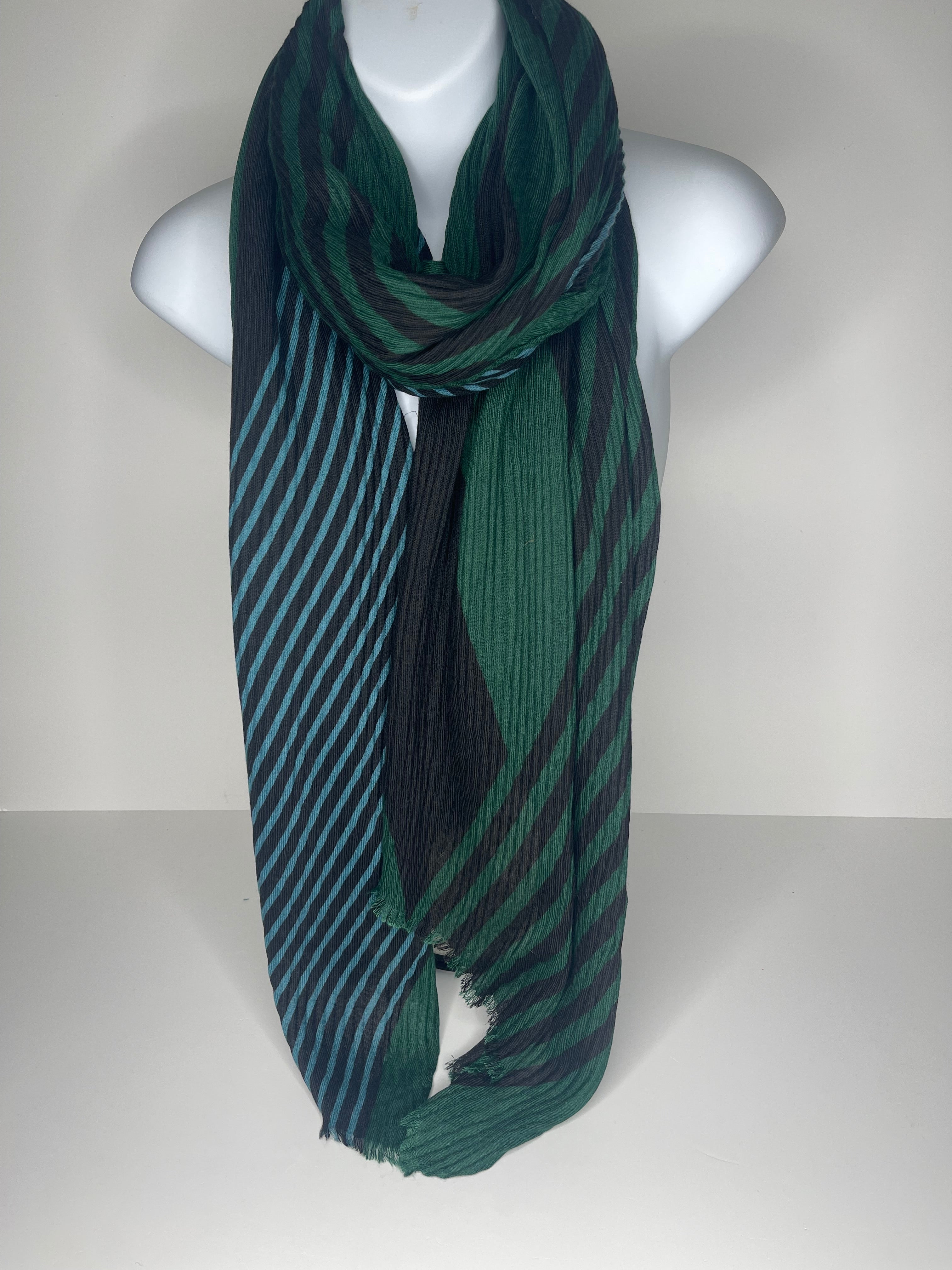 Lighter weight pleated abstract print scarf in shades of green, black and denim blue