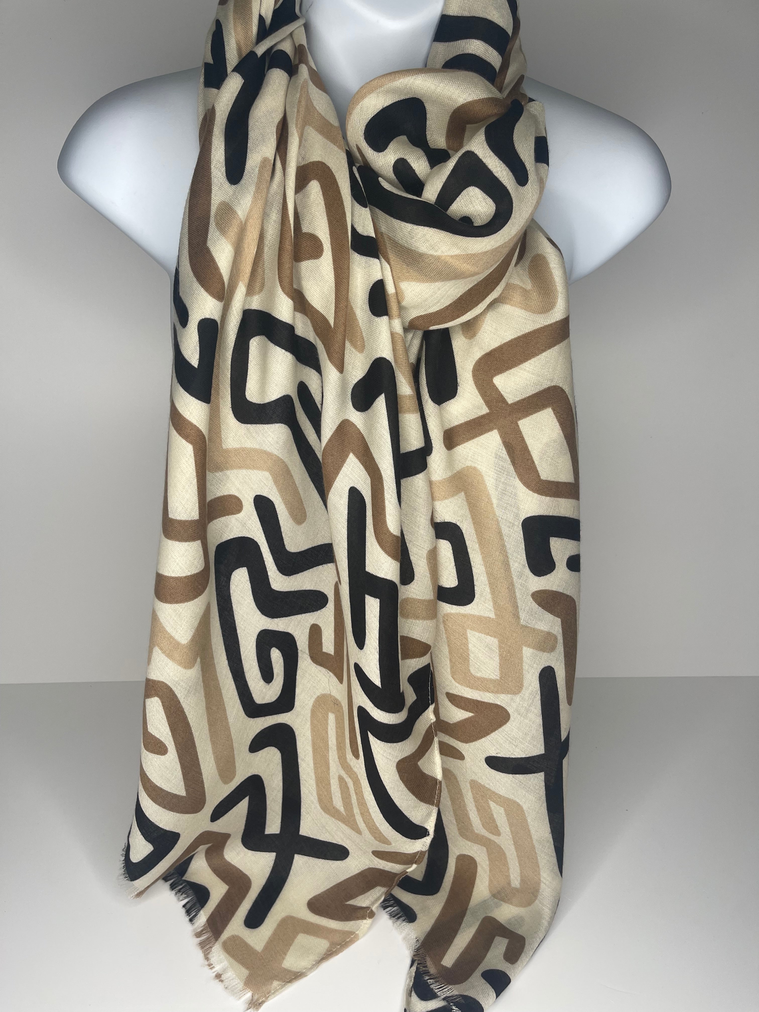 Lighter weight abstract print scarf in shades of cream, black, beige and brown