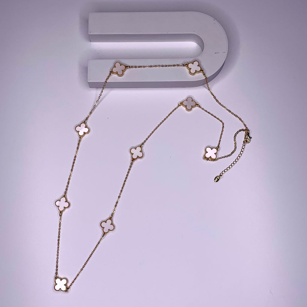 Long necklace with pearl white four-leaf clover stations on a gold paper chain
