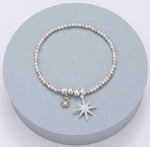 Elasticated bracelet with silver and rose gold beading and silver diamanté shining star
