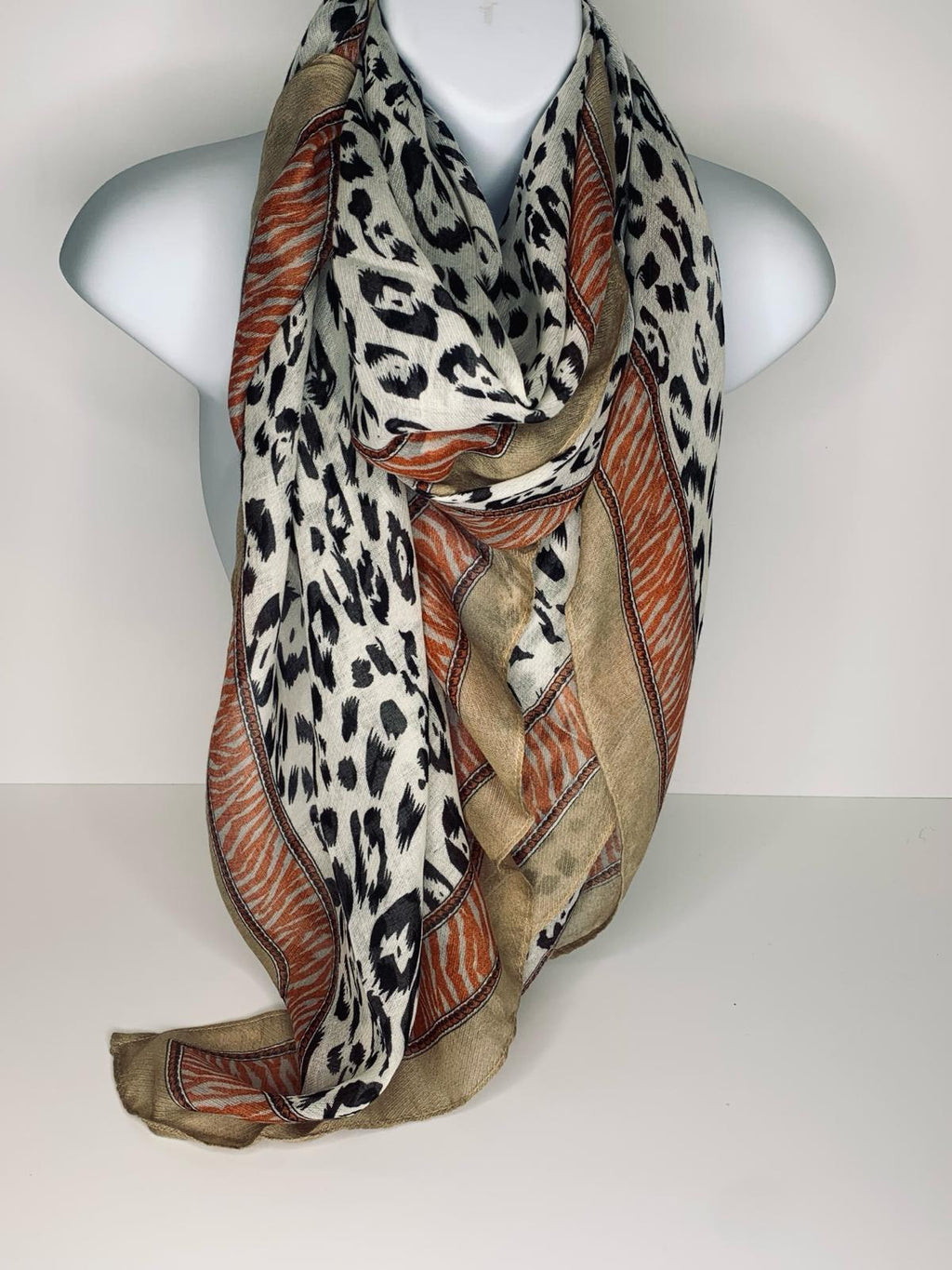 Animal print scarf in shades of white, orange, oatmeal and black