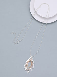 Long necklace, with battered silver, rose gold and gold metal open-leaf pendant - on a silver chain