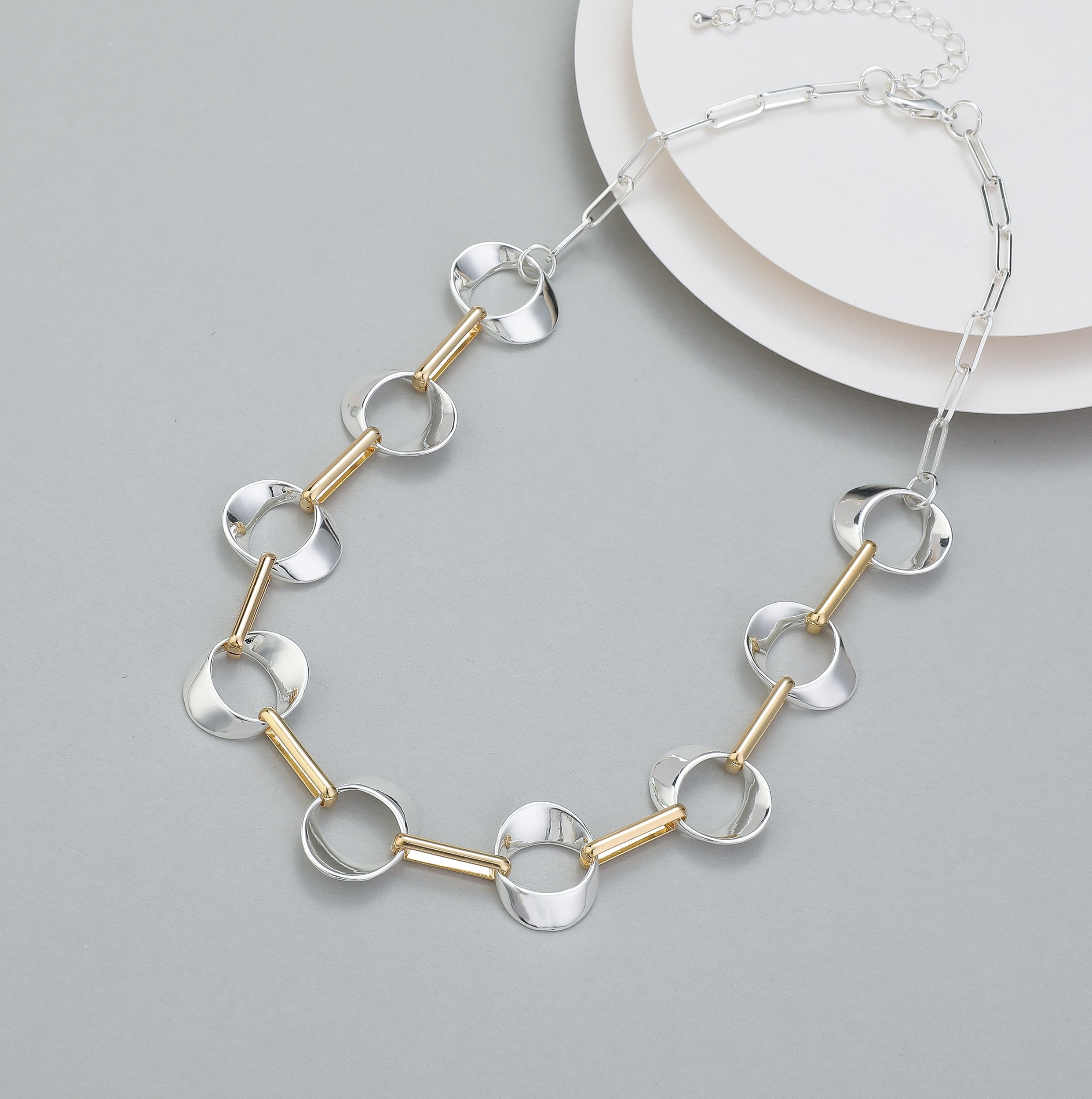 Short necklace, with shiny silver interlinked circles and gold fasteners - on a silver chain