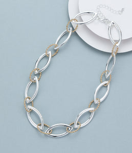 Short necklace, with shiny silver interlinked rings and twisted gold rings - on a silver chain