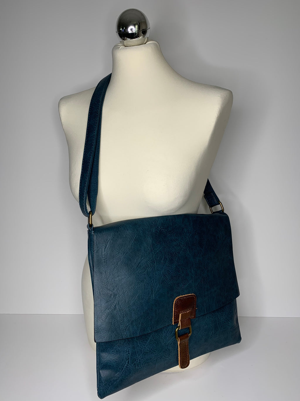 Vegan leather, cross-body satchel bag with top zip, magnetic dot closure and adjustable strap in lakeland blue